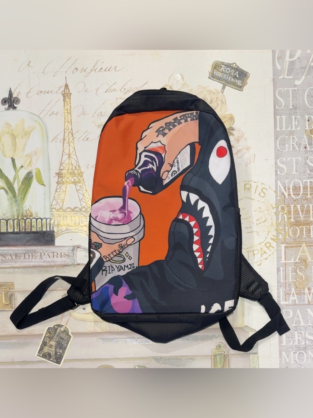 Bold Backpack, Graphic Print, Shark Mouth, A Hand Pouring Liquid